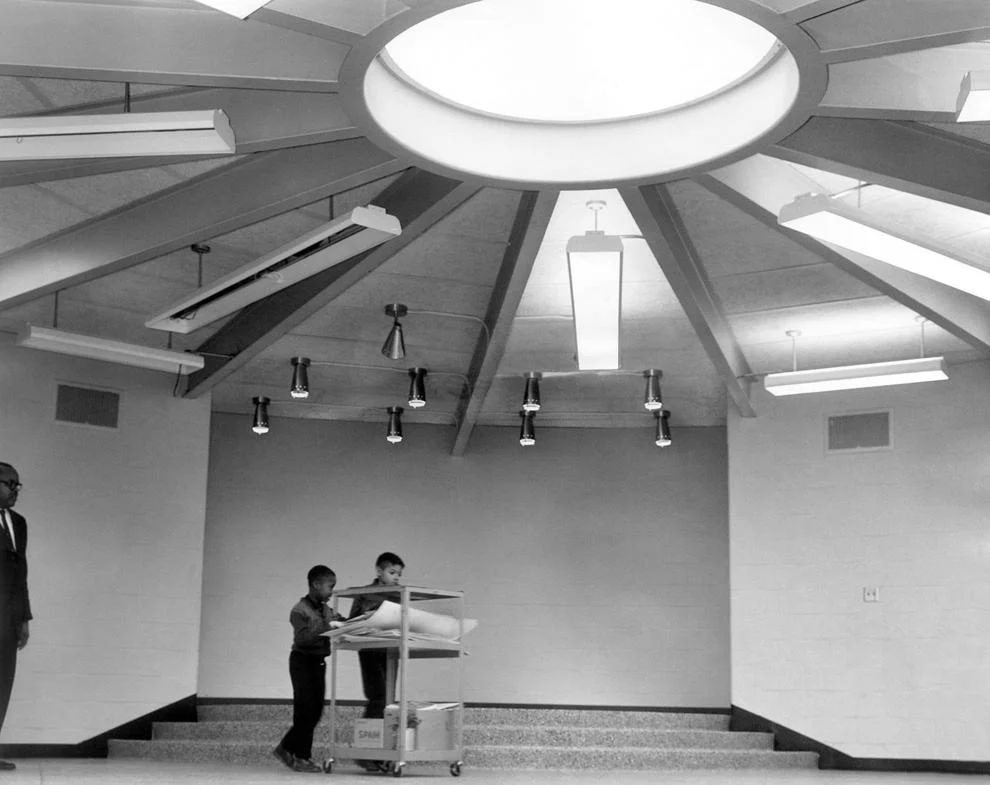 Albert Johnson, 7, and Ronald Beard, 8, rolled instructional materials into the round all-purpose room at Woodville School in Richmond’s East End, 1962.