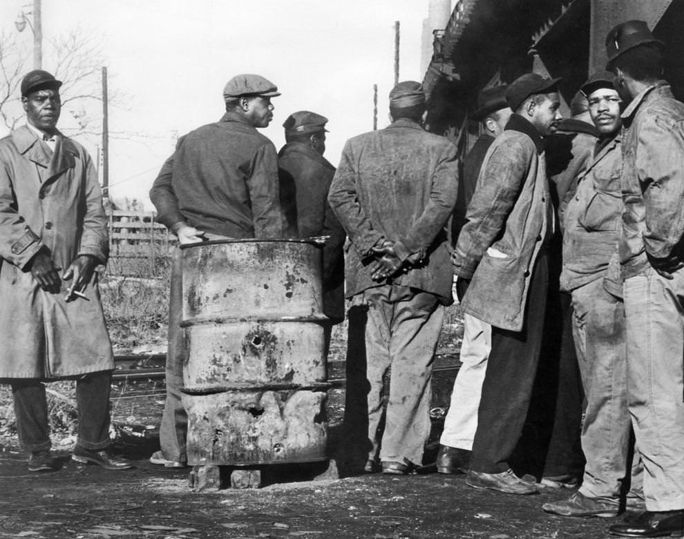 Men waited at a railroad trestle at 14th Street, south of East Cary Street, in Richmond, 1963.