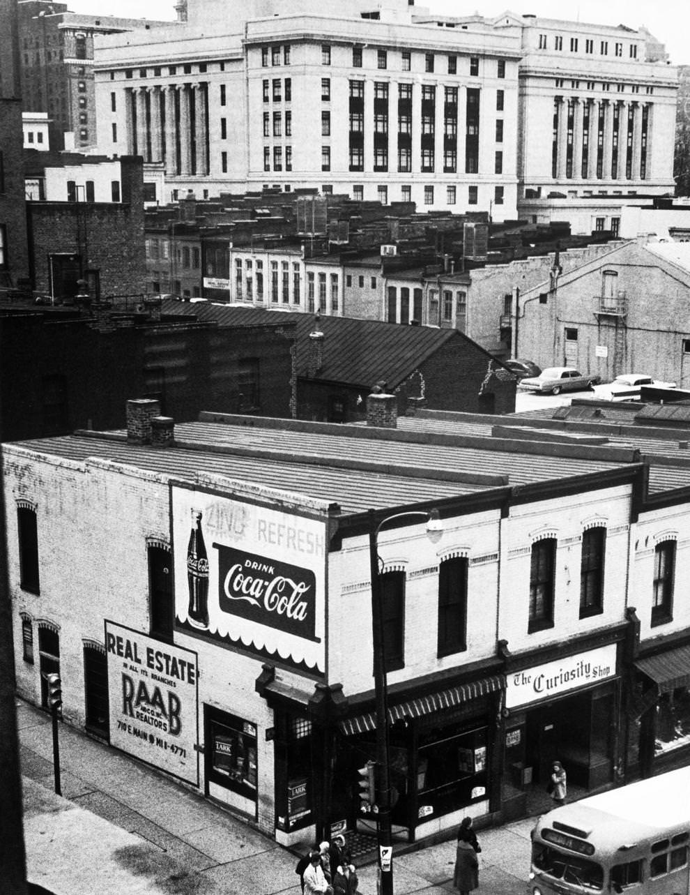 Plans were announced for an 18-story office building at Seventh and Main streets in downtown Richmond, which would displace smaller shops and buildings at the site, 1964.