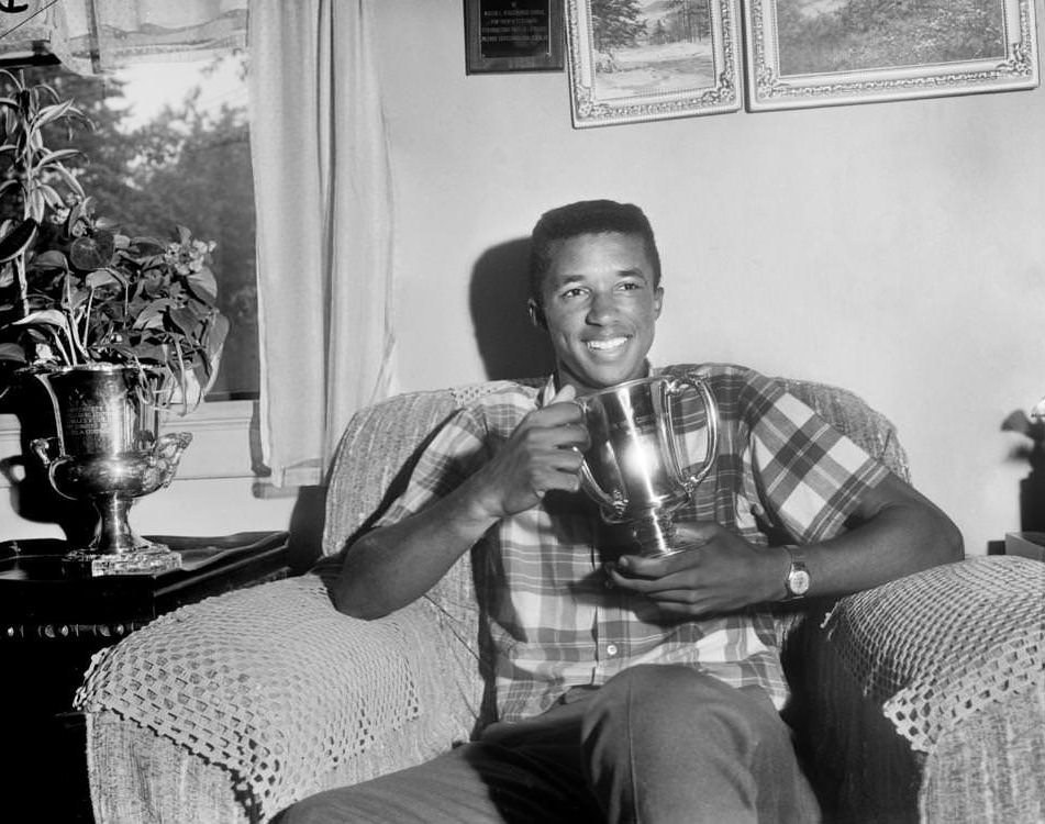 Tennis star Arthur Ashe Jr. admired his Eastern Grass Court Championship trophy at his home on Aug. 10, 1964.