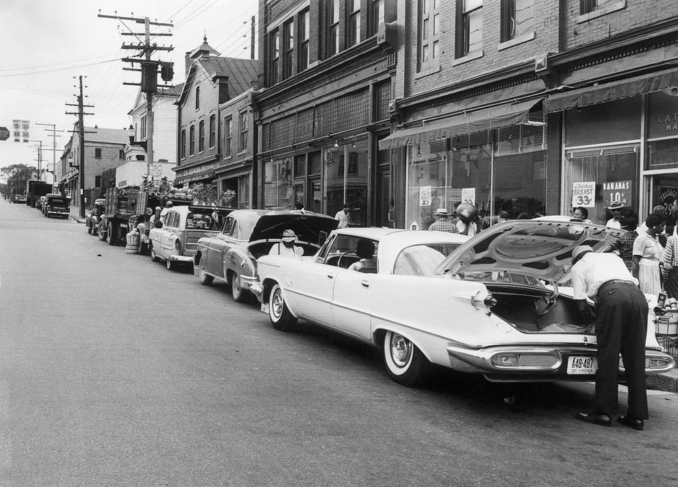 Farmers and merchants in the market area of 17th and East Franklin streets sold produce and goods curbside, paying a fee of 50 cents a day for a spot to park, 1961.