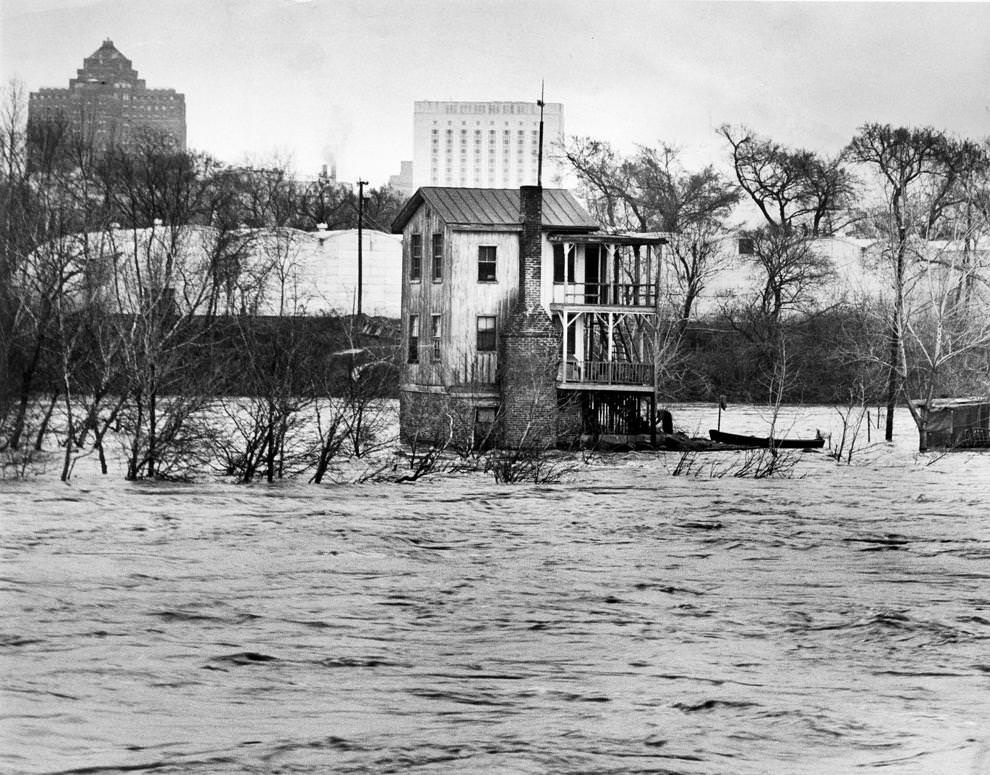 The roiling waters of the James River surrounded a dwelling on Sharp's Island near the 14th Street bridge, 1963.