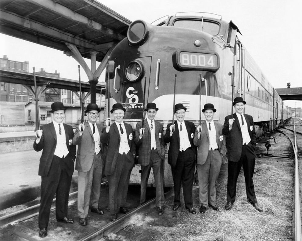 The salesmen for the Chesapeake and Ohio Railway posing in front of a train, 1962.
