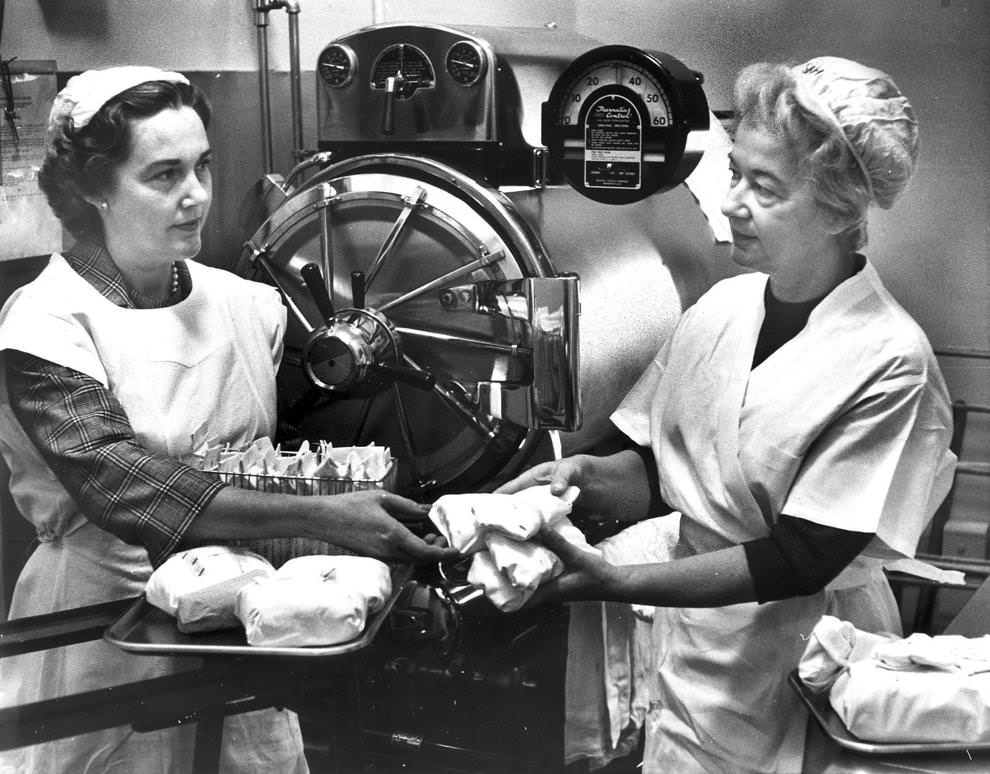 Mary Reynolds (left) and Mrs. M.W. Clark prepared medical instruments for processing in the autoclave at Sheltering Arms Hospital, 1962.