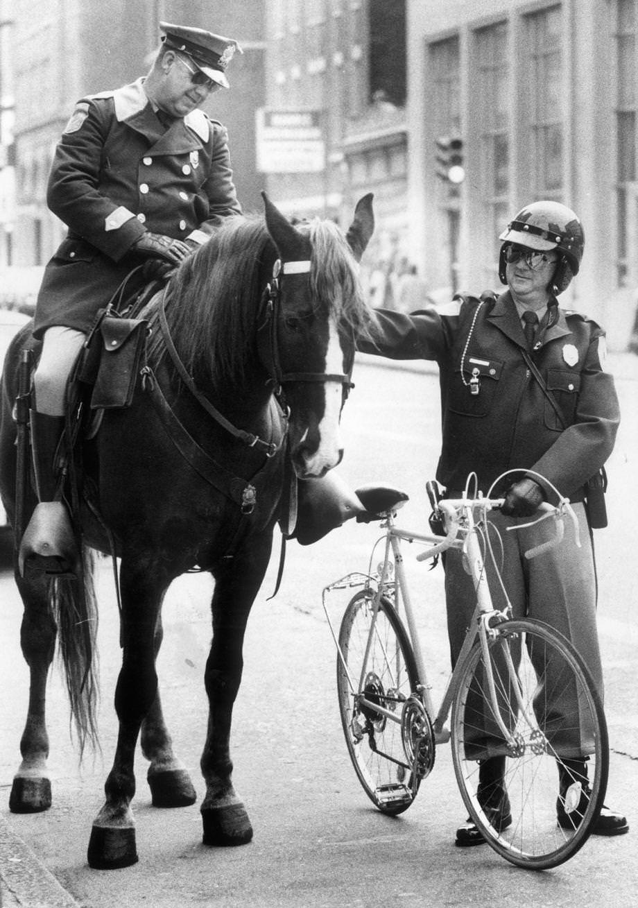 Richmond police bicycle patrolman William W. Fuller Jr. stopped for a downtown chat with policeman Glen A. Brinson of the mounted unit, 1973.
