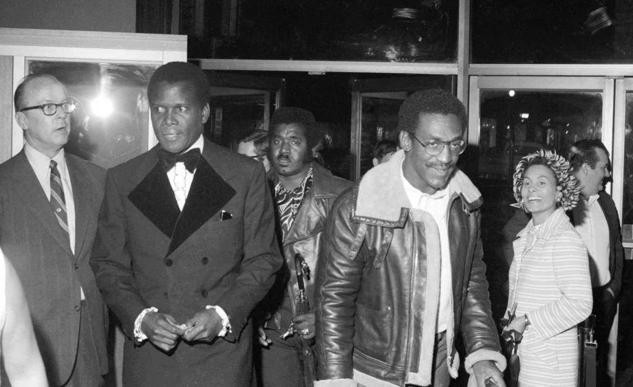 Sidney Poitier (left) and Bill Cosby entered the Loew's Theater for a benefit to raise money to rebuild Virginia Union University's Coburn Chapel, which burned in 1970.