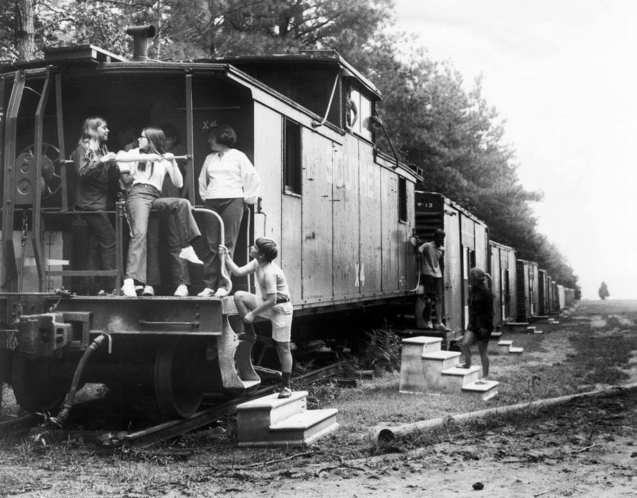 Members of Camp Willow Run gathered outside their dormitories, which were former train boxcars, 1971.