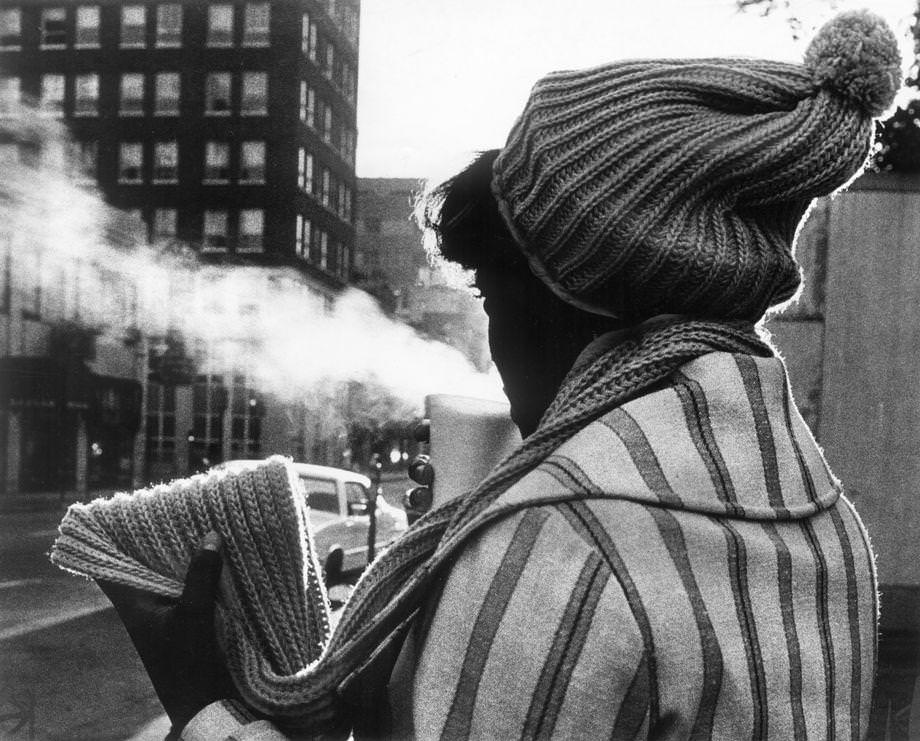 Barbara Smith warmed up with a cup of hot coffee on her way to work on a cold day in downtown Richmond, 1971.