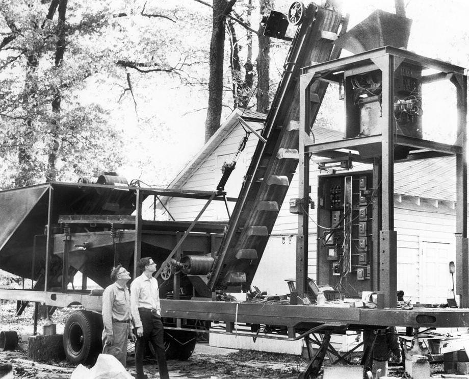 Noah G. Teates Sr. (left) and son Grove operated a machine outside the family’s Hanover County home, 1971.