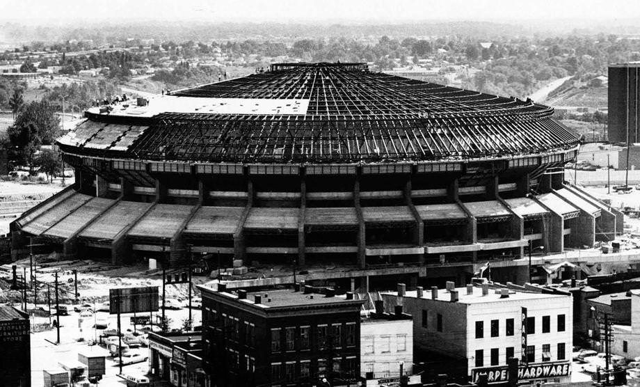 With the superstructure for the roof of Richmond's coliseum inb place, workmen are busy putting the roofing on the massive structure, 1970