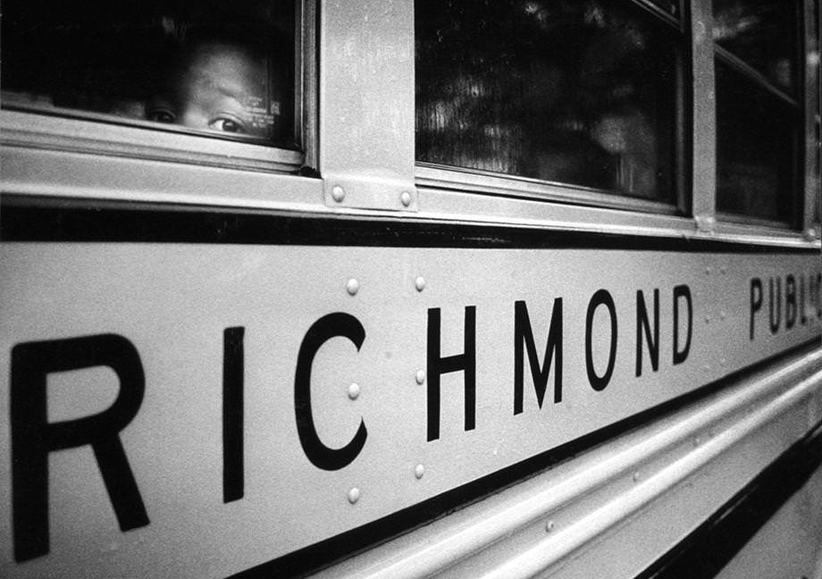 A black student peered out of a Richmond Public Schools bus on a rainy morning in August 1970 as cross-town busing began in the city.