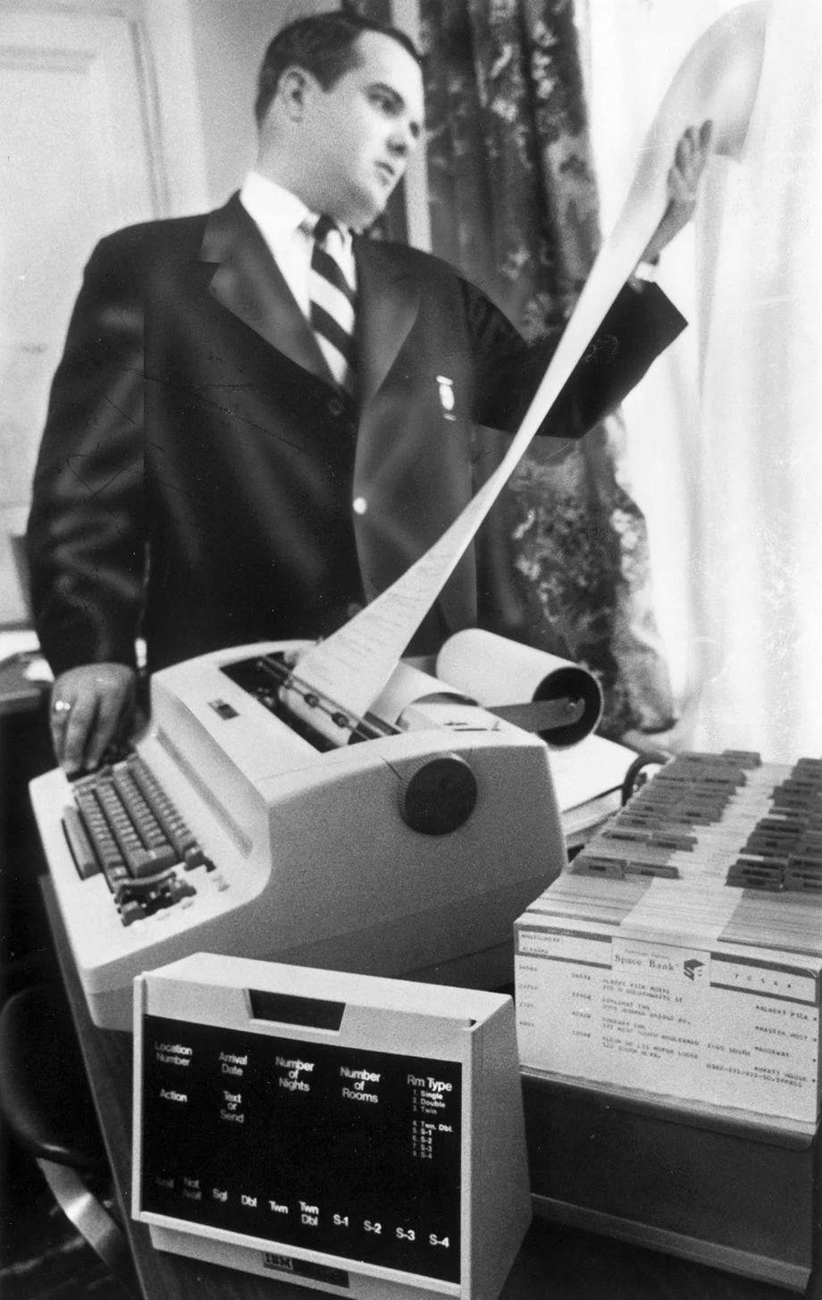 David Erskine, reservations manager for the Hotel John Marshall in Richmond, reviewed a printout from a new computer system that linked the hotel with 2,000 lodging sites nationwide, 1970.