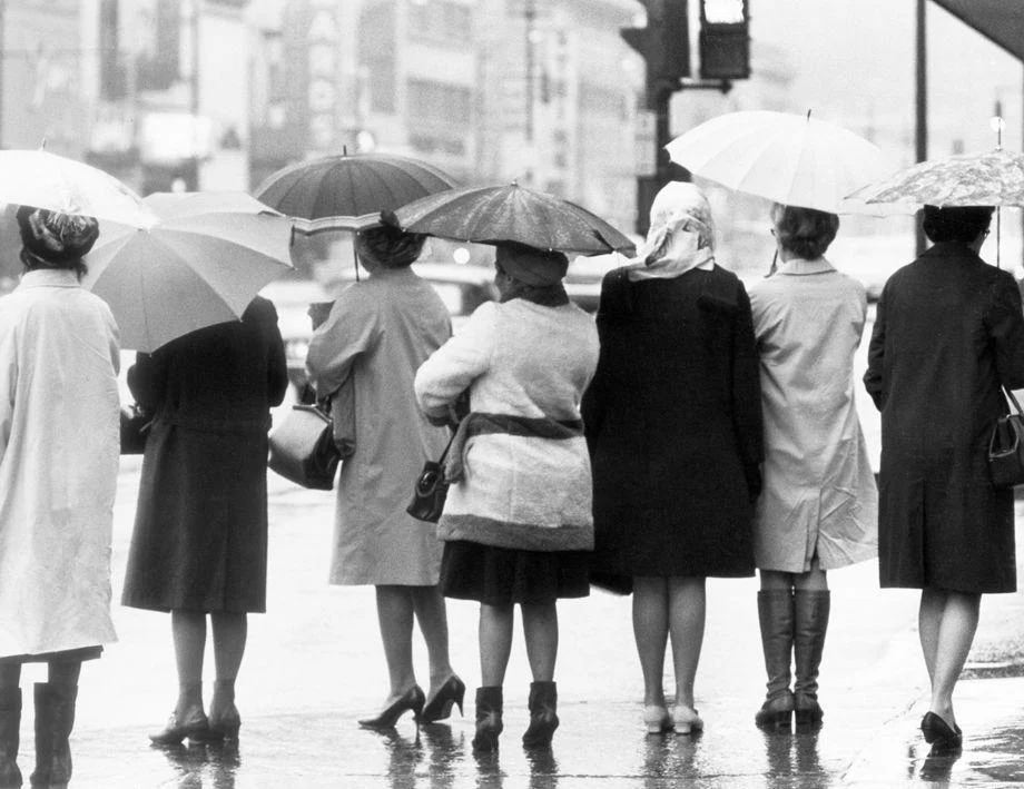 A line of umbrella-toting women waited for the bus on East Broad Street in downtown Richmond on a rainy day, 1970.