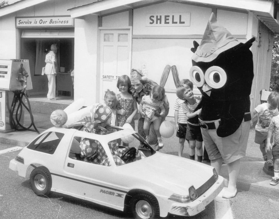 Safety Town Opens - This summer's installment of Safety Town opened at Azalea Mall yesterday, and among those on hand were Marcia Carr as Clyde the Clown (in car), Leigh Burke as Cupid the Clown, and Mike Martin as the owl.