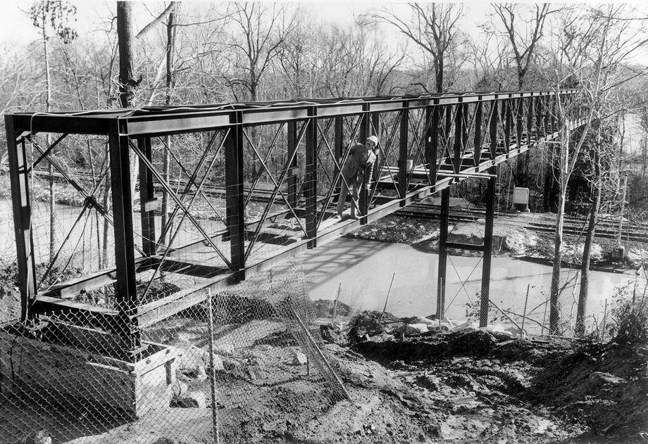 Bill Heindl, a co-founder of the Heindl-Evans Inc. construction firm, oversaw progress on building a footbridge in James River Park at Texas Avenue in Richmond, 1978.