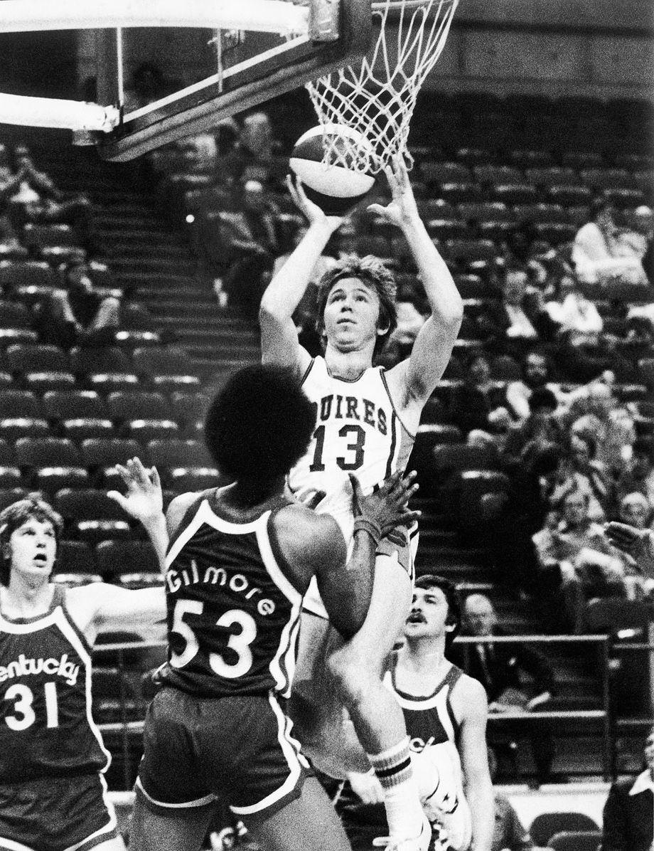 Dave Twardzik of the Squires shot over Artis Gilmore of the Kentucky Colonels en route to a Squires victory before a crowd of only 1,017 at the Coliseum, 1976.