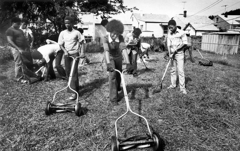 Richmond youths did yard work as part of a summer employment assignment administered by the Richmond Area Manpower Planning Systems, 1976.
