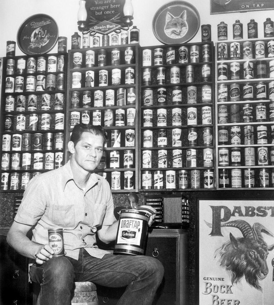 Ronald J. Roller of Petersburg posed with his beer can collection, which totaled almost 1,300 after 18 years of collecting, 1976.