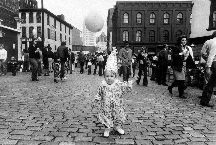 Young reveler Christopher Gibbs held a balloon while thousands wandered Shockoe Slip in Richmond at the Great Pumpkin Party, 1976.