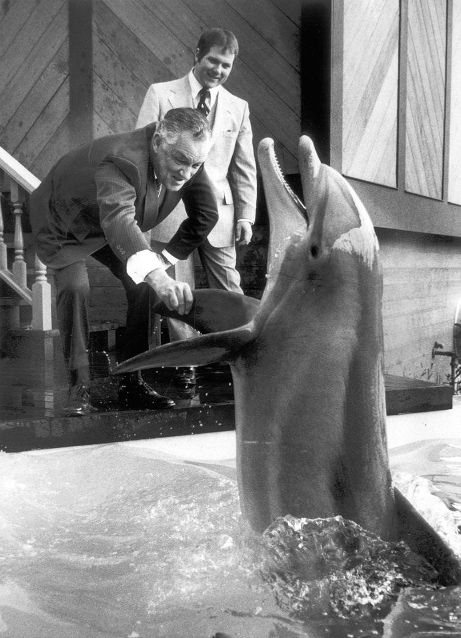 Gov. Mills E. Godwin Jr. greeted a porpoise on the opening day of the Kings Dominion in Doswell, 1975.