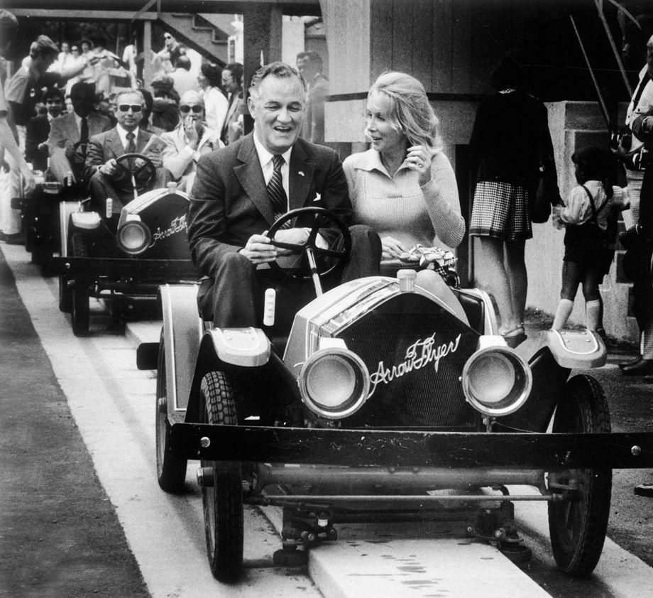 Gov. Mills E. Godwin Jr. and Mrs. August Busch III rode the lead car around the Le Mans track in the French village of the new Busch Gardens: The Old Country theme park near Williamsburg, 1975.