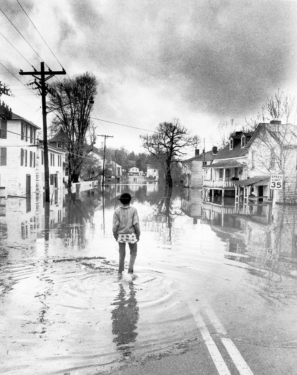 Juanita Wade walked down the flooded Main Street in Columbia, a James River town in Fluvanna County near Fork Union, April 1987.