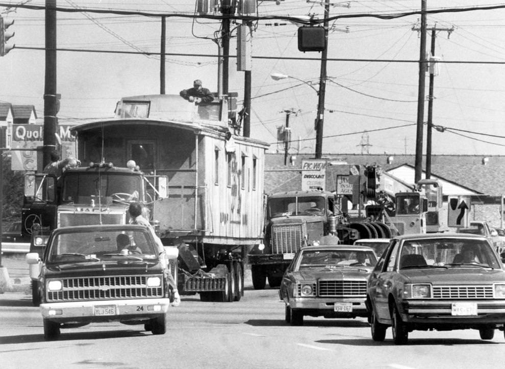 An old wooden caboose was hauled by truck on West Broad Street en route to John B. Cary Elementary School in Richmond, 1981