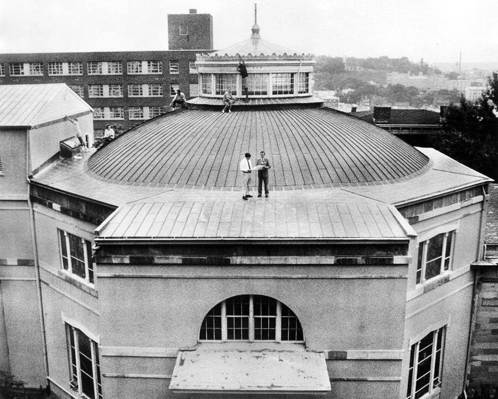 Historic Richmond Foundation leader John G. Zehmer Jr. (center left) reviewed roof plans with architect Kenneth MacIlroy at Monumental Church on East Broad Street in Richmond.