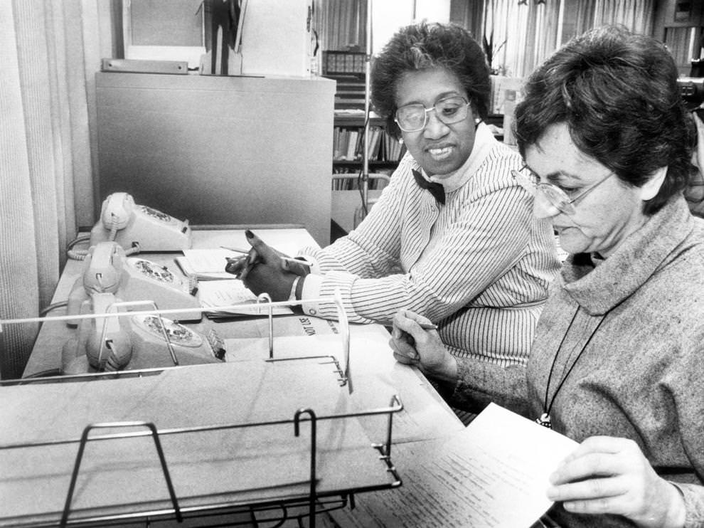 Delores Green (left) and Roxie Kricorian waited for calls on the Homework Hot Line, which had just begun offering afterschool help to Richmond students, 1984