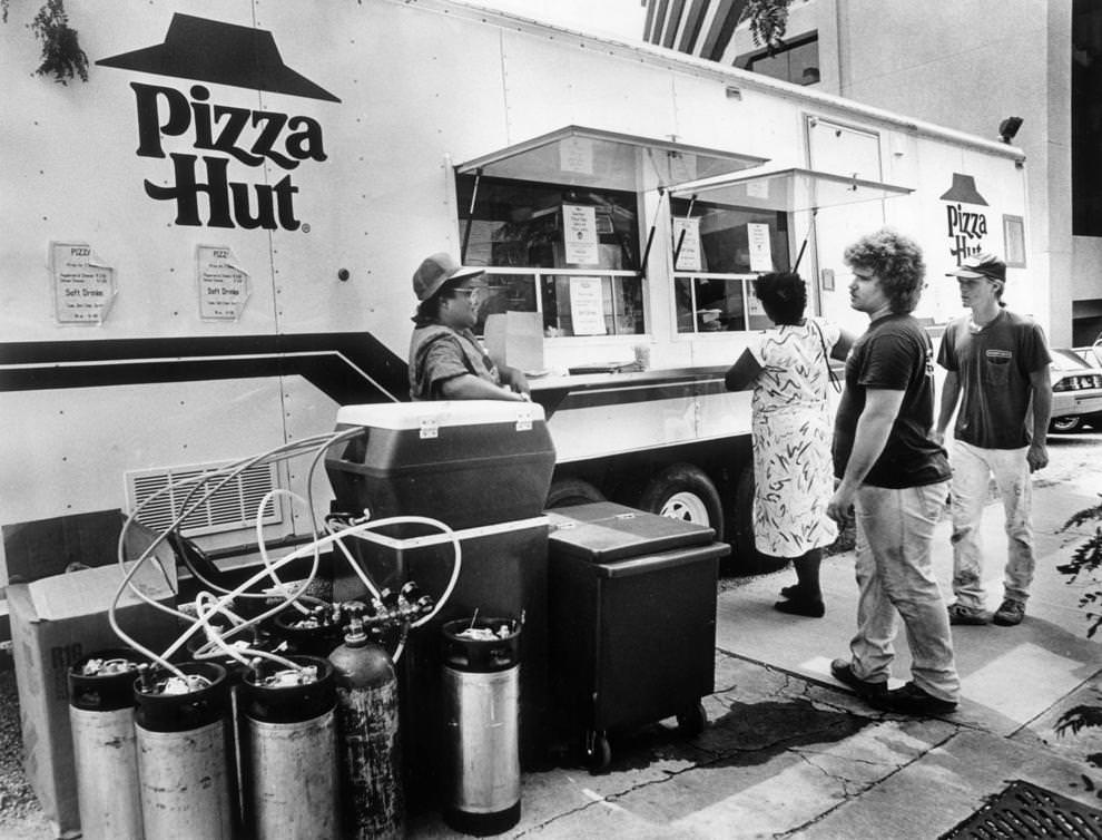 Norma Ray (left) served beverages at a Pizza Hut trailer outside Main Street Centre in downtown Richmond, 1988