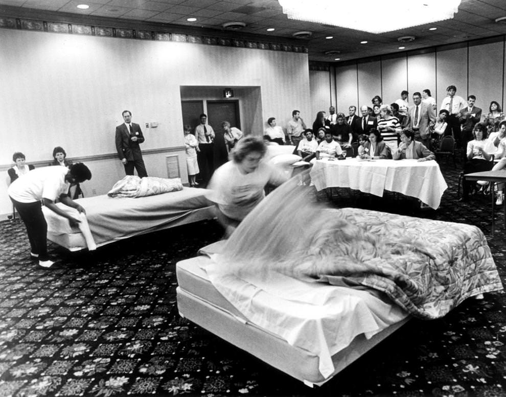 Housekeepers Josephine Scott (left) and Joy Brown competed in a regional Super 8 Motel bed-making competition at a Radisson Hotel ballroom in downtown Richmond, 1991