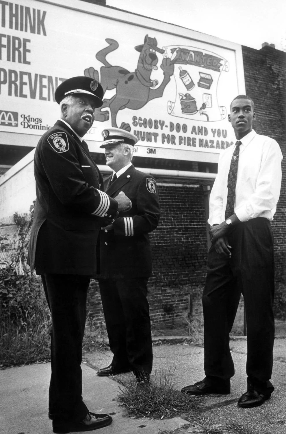 Richmond fire officials (from left) Ronald Lewis and Harold Beavers Jr. joined Robert El stood in front of a billboard El designed, 1990