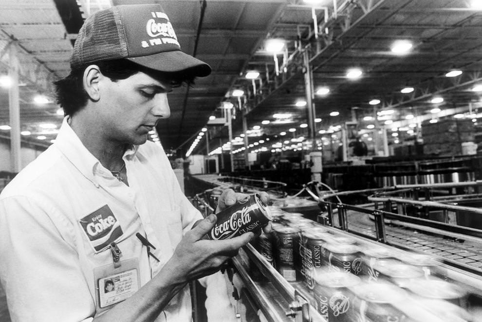 Quality assurance technician Blake Dingler examined Coca-Cola cans as they moved through Mid-Atlantic Coca-Cola Bottling Co.’s new production plant in eastern Henrico County, 1990.