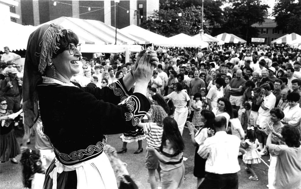 Rena Tsengas leads the beat from the stage while patrons dance in front of the large crowd at the 1992 Greek Festival in Richmond, Va. on May 31.