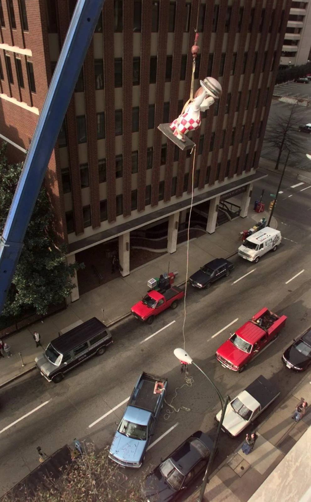 While a guiding rope keep him from swinging, a 7-foot tall Big Boy statue is lifted into the sixth floor office of Kelly O'Keefe with Cadmuscom advertising in the 700 block of East Franklin Street Saturday morning, 1998