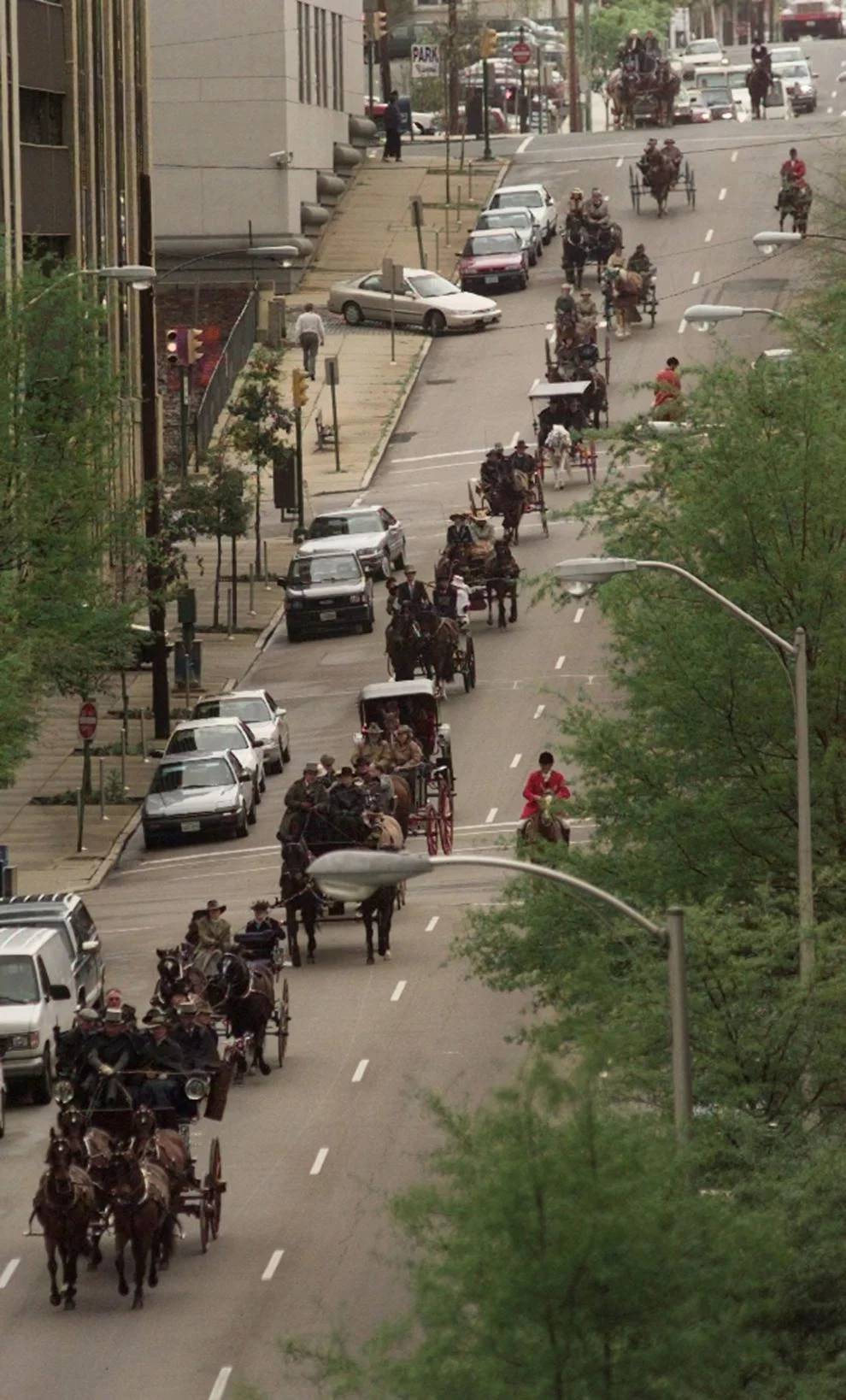 A line of carriages rolls down Cary Street on its way to the Capitol to kick off the Strawberry Hills Races this weekend. April 10, 1998