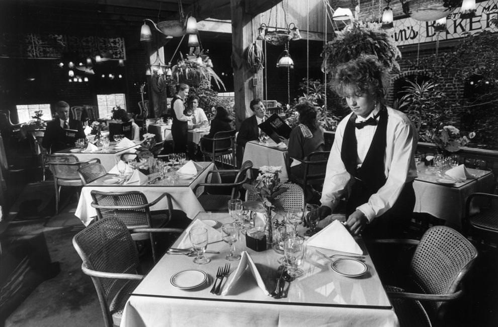 Survival of the fittest--Waitress Julie Penna arranges a table on the third floor of the 19th century tobacco warehouse-turned four-floor restaurant and nightclub complex, 1992