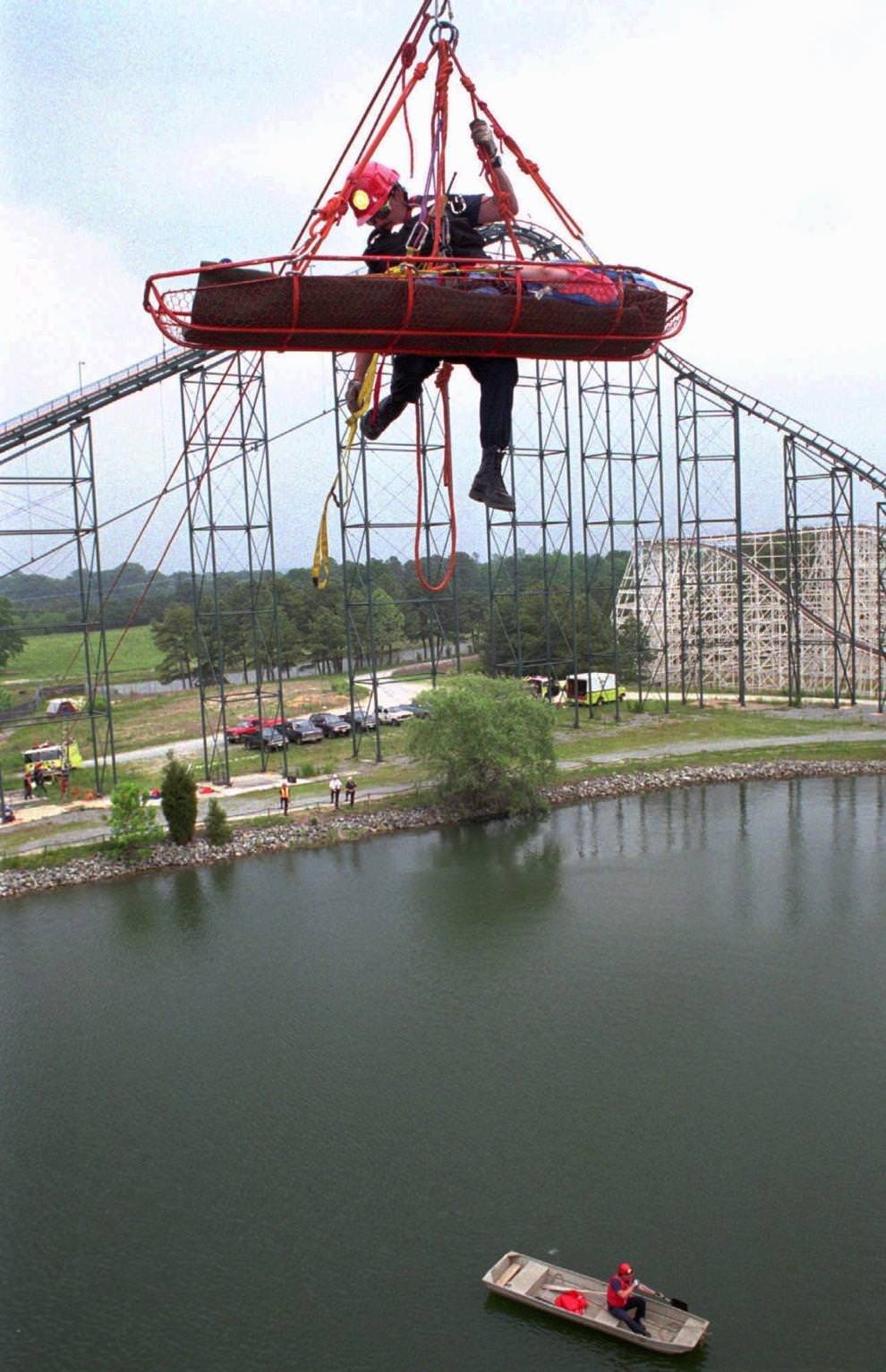 Wendy Wagner is transported across the lake at Paramount's Kings Dominion's Anaconda ride by Henrico firefighter Larry Bourne Wednesday, May 17, 1995, during a practice rescue.