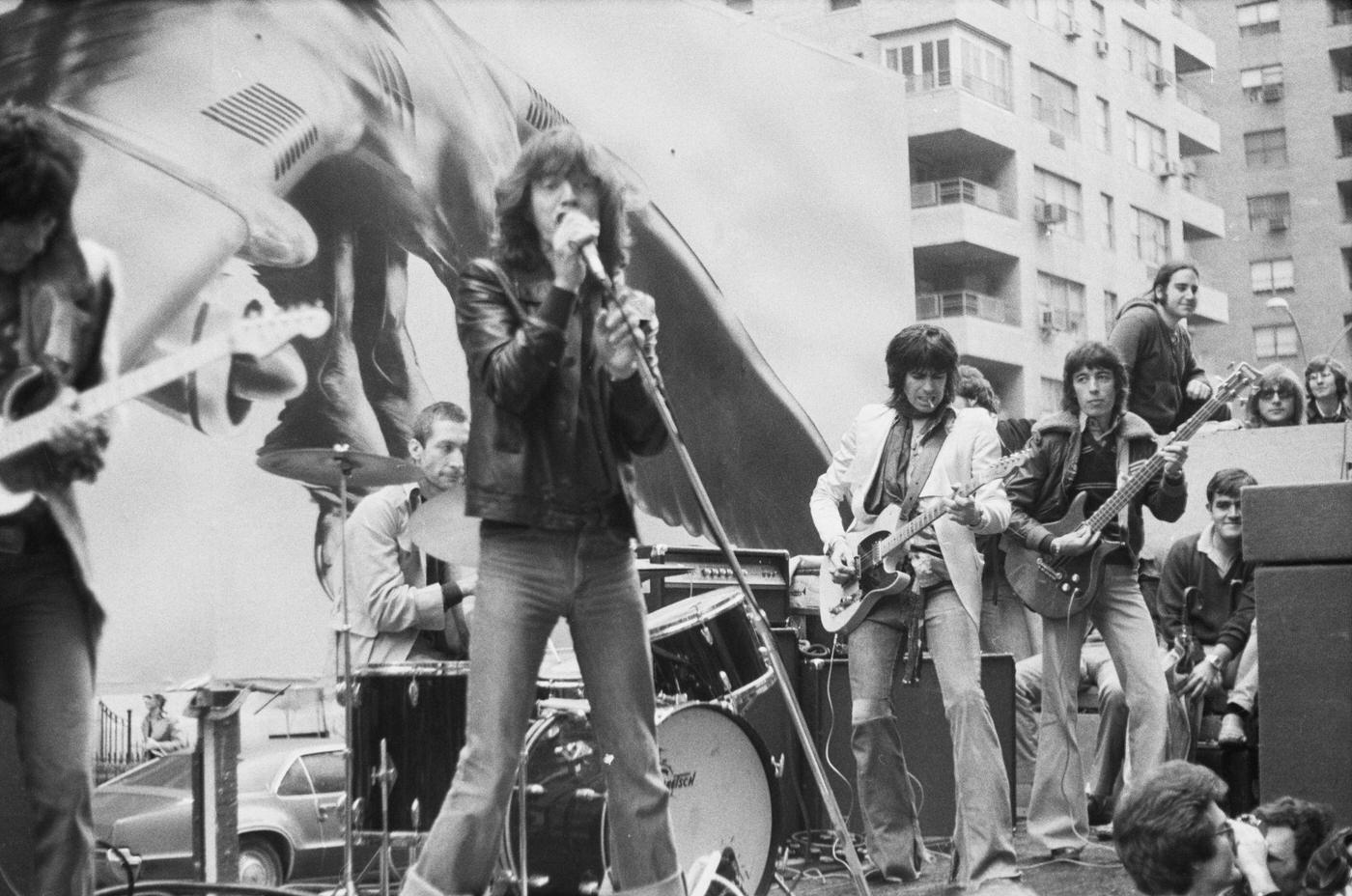Ronnie Wood, Charlie Watts, Mick Jagger, Keith Richards, and Bill Wyman perform on a flatbed truck on Fifth Avenue, New York City, 1975.