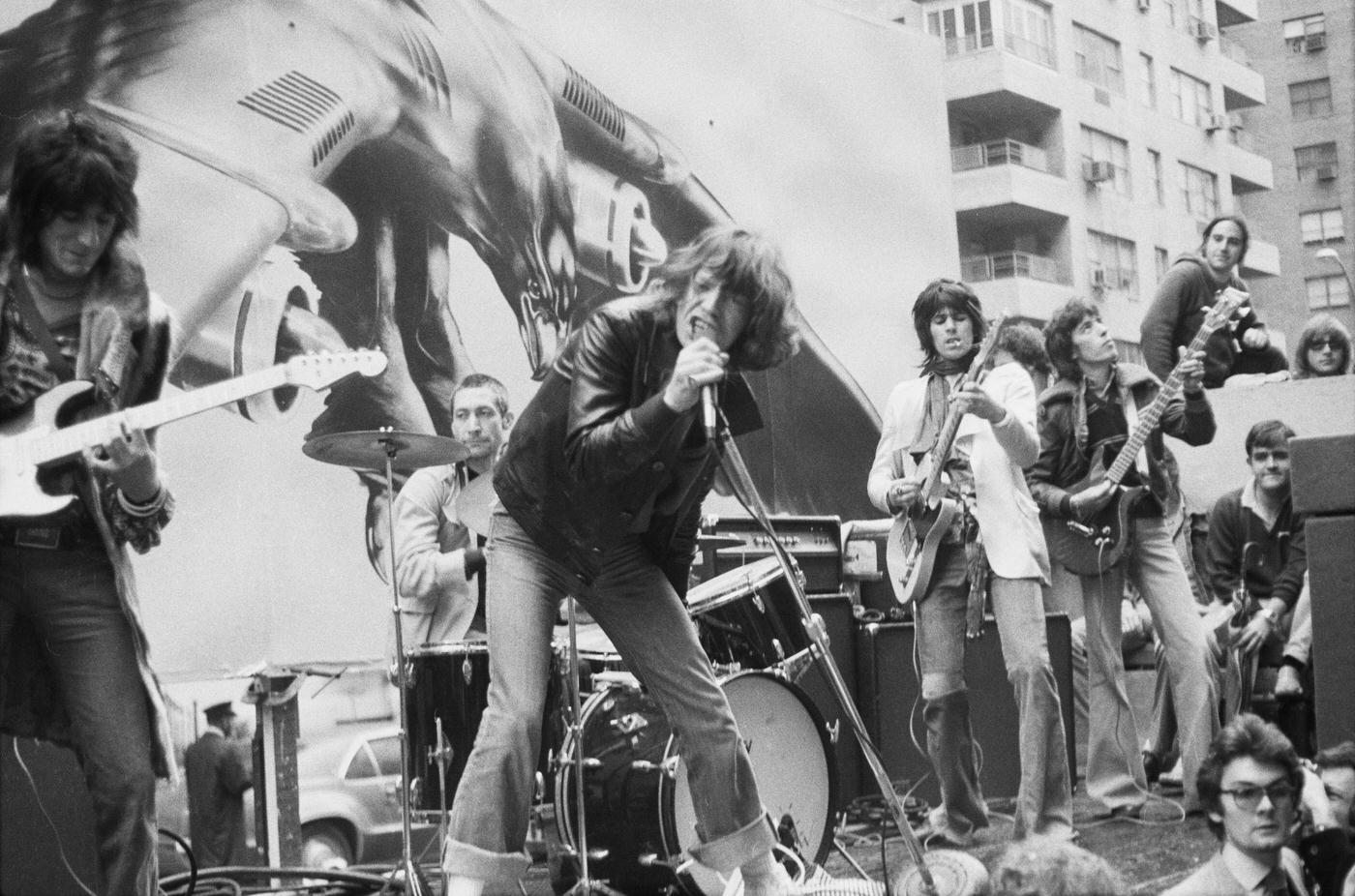 Ronnie Wood, Charlie Watts, Mick Jagger, Keith Richards, and Bill Wyman perform on a flatbed truck on Fifth Avenue, New York City, 1975.