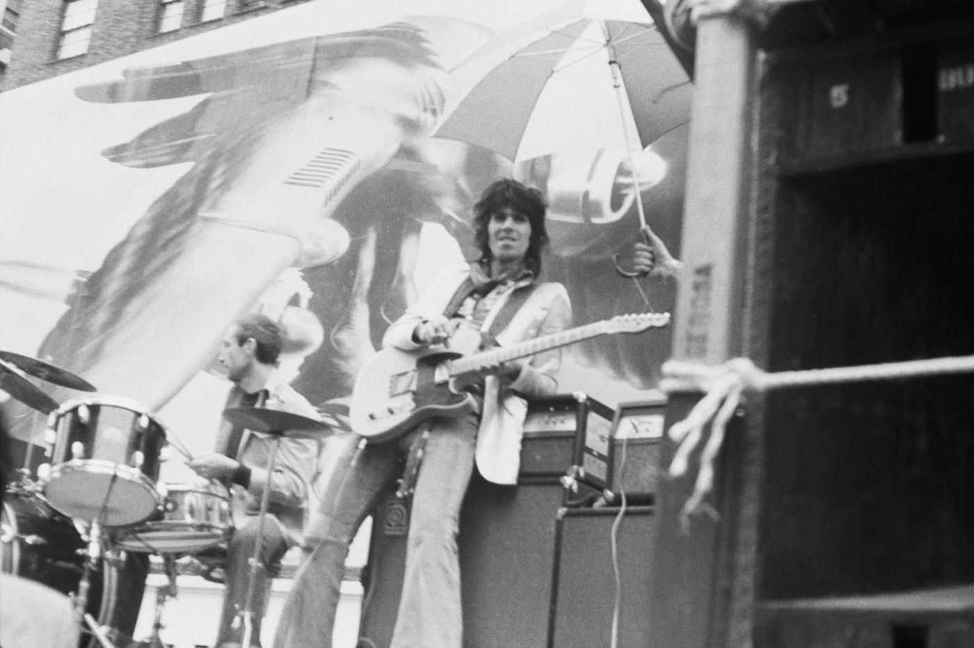 Charlie Watts and Keith Richards perform on a flatbed truck on Fifth Avenue, New York City, 1975.