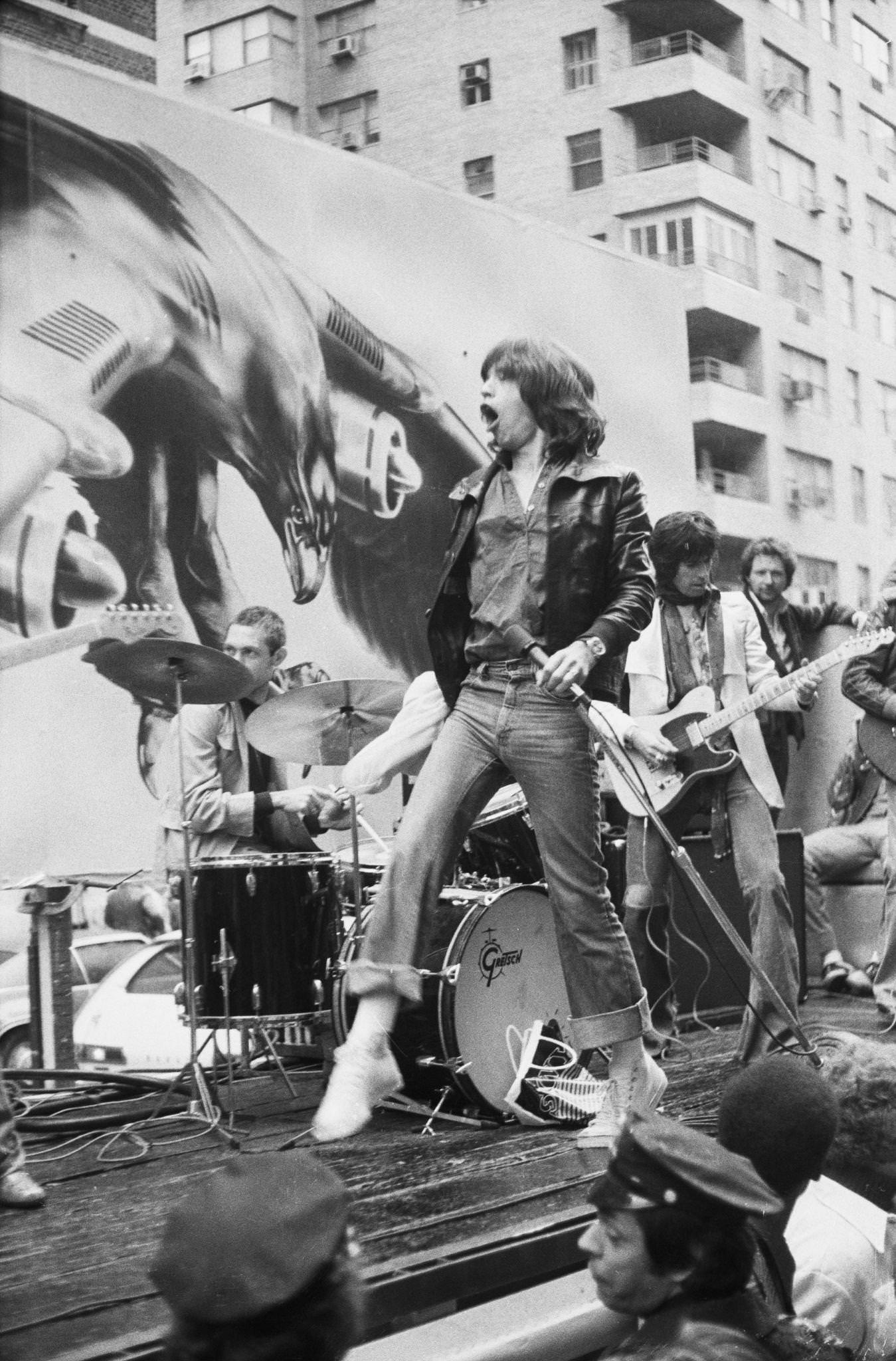 Charlie Watts, Mick Jagger, and Keith Richards perform on a flatbed truck on Fifth Avenue, New York City, 1975.