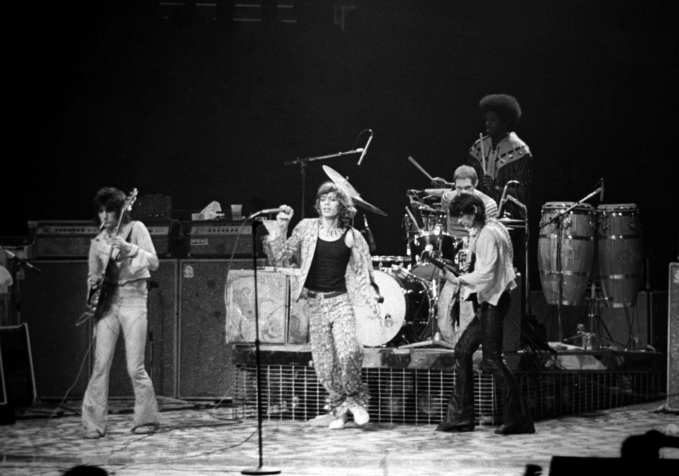 Ronnie Wood, Mick Jagger, Keith Richards, and Charlie Watts perform with percussionist Ollie Brown at Madison Square Garden during the band's 'Tour of America '75" on June 25, 1975, in New York, New York.