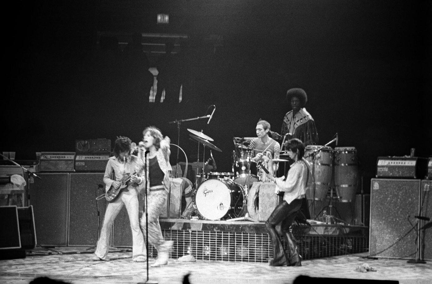 Ronnie Wood, Mick Jagger, Charlie Watts, and Keith Richards perform with percussionist Ollie Brown at Madison Square Garden during the band's "Tour of America '75" on June 25, 1975, in New York, New York.