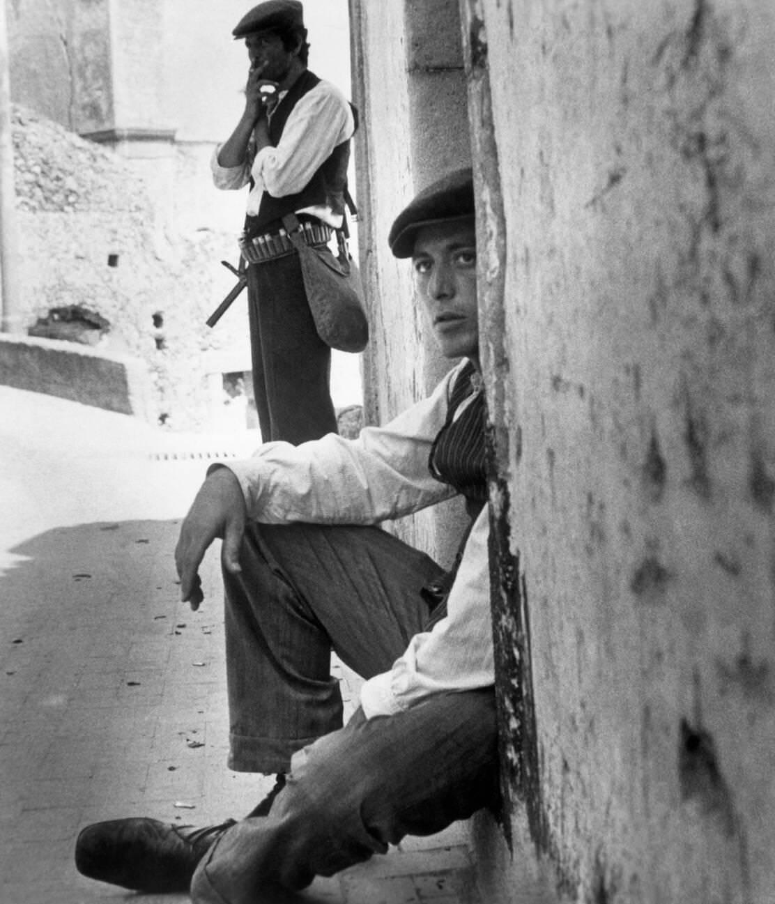 Scene from The Godfather (1972) featuring Angelo Infanti, Al Pacino, and Sicilian backdrop.