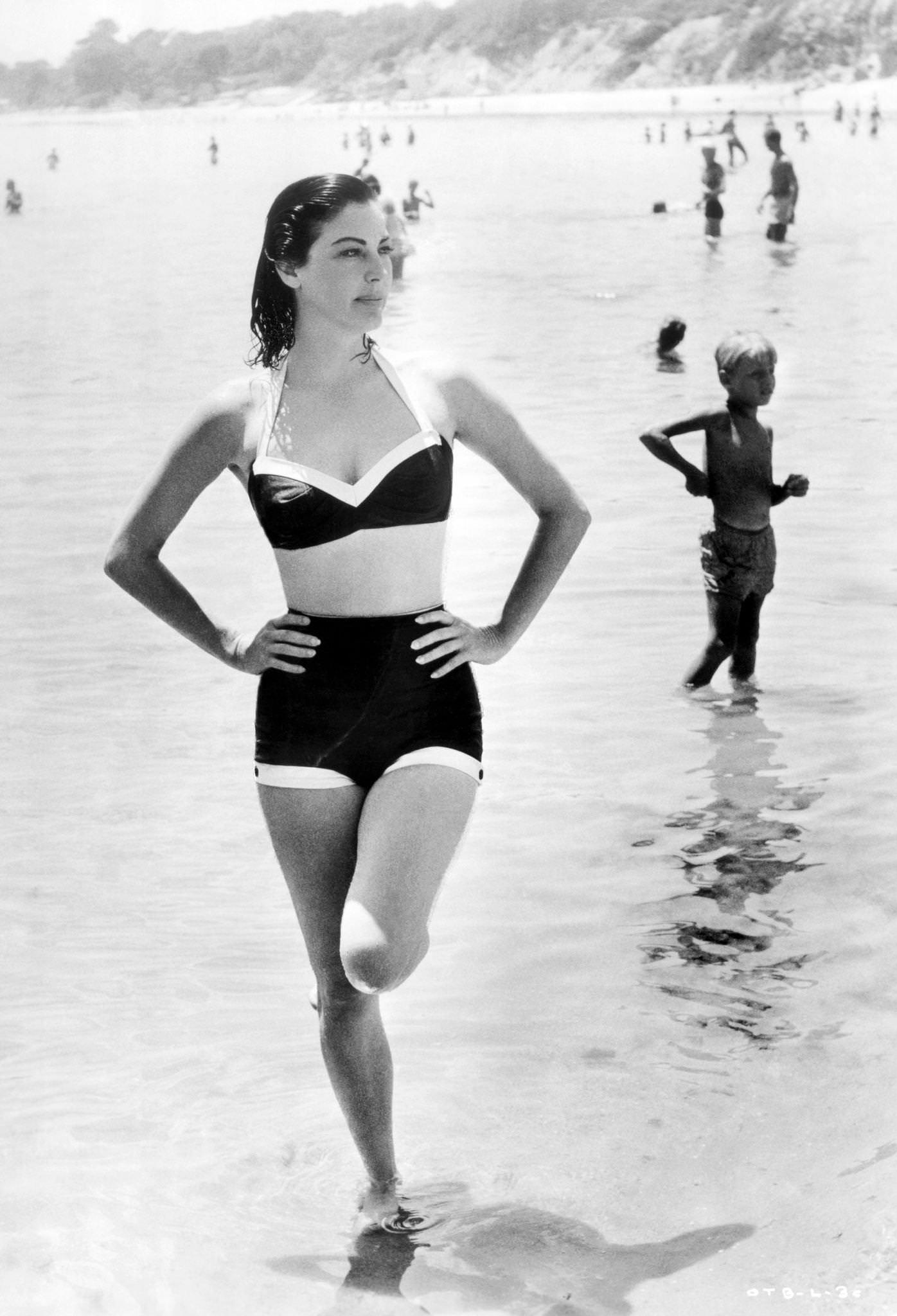 Ava Gardner on the beach in a two-piece bathing suit