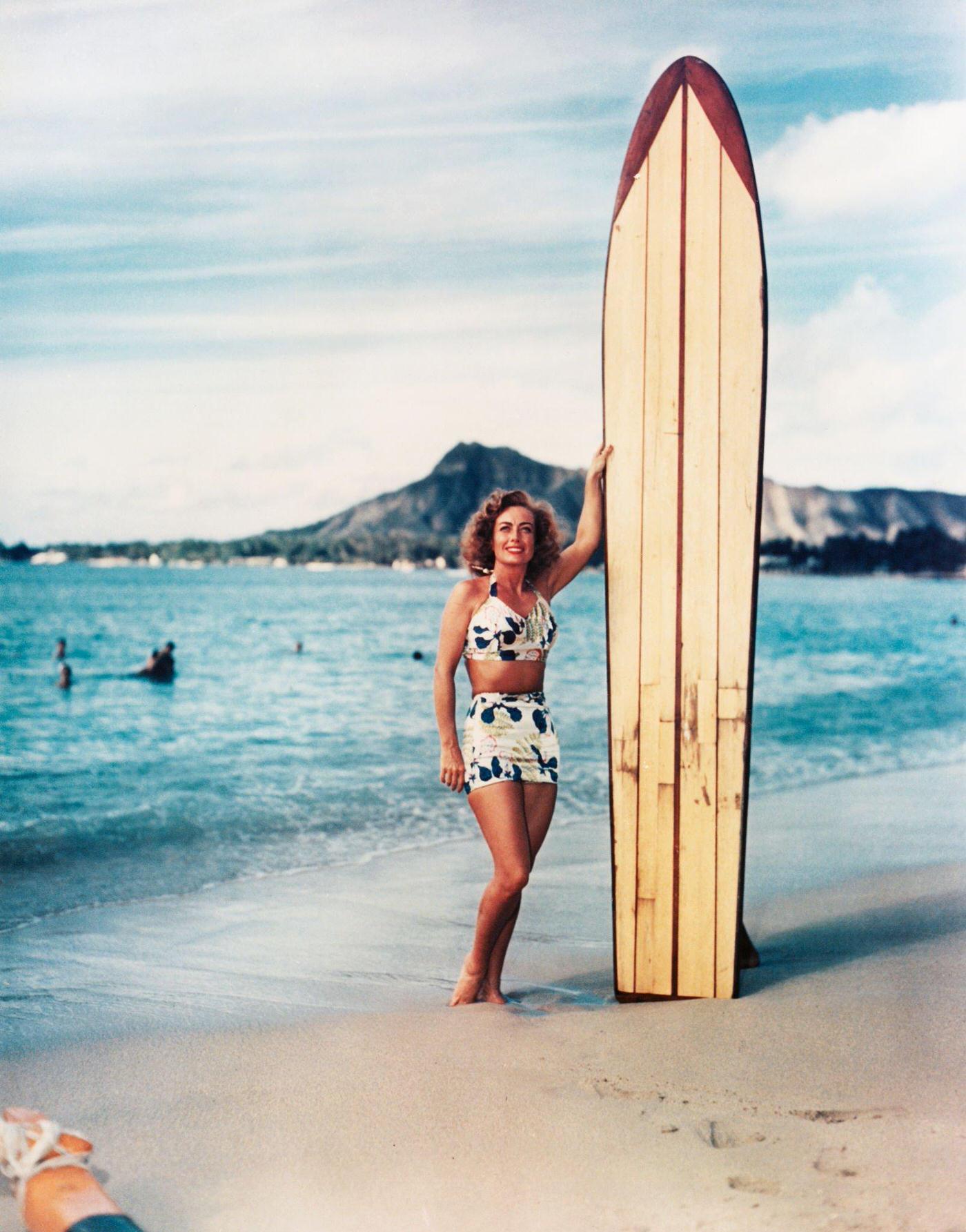 Joan Crawford holding a large surfboard