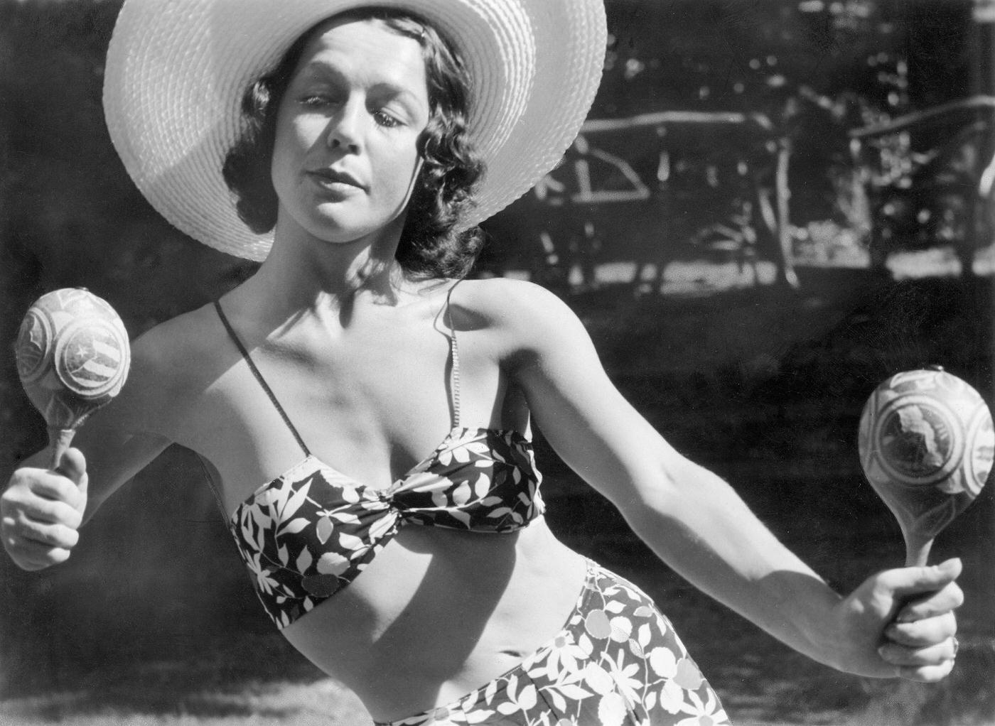 Ilse Meudtner, dancer, Germany, posing in a bikini with a straw hat and rattles