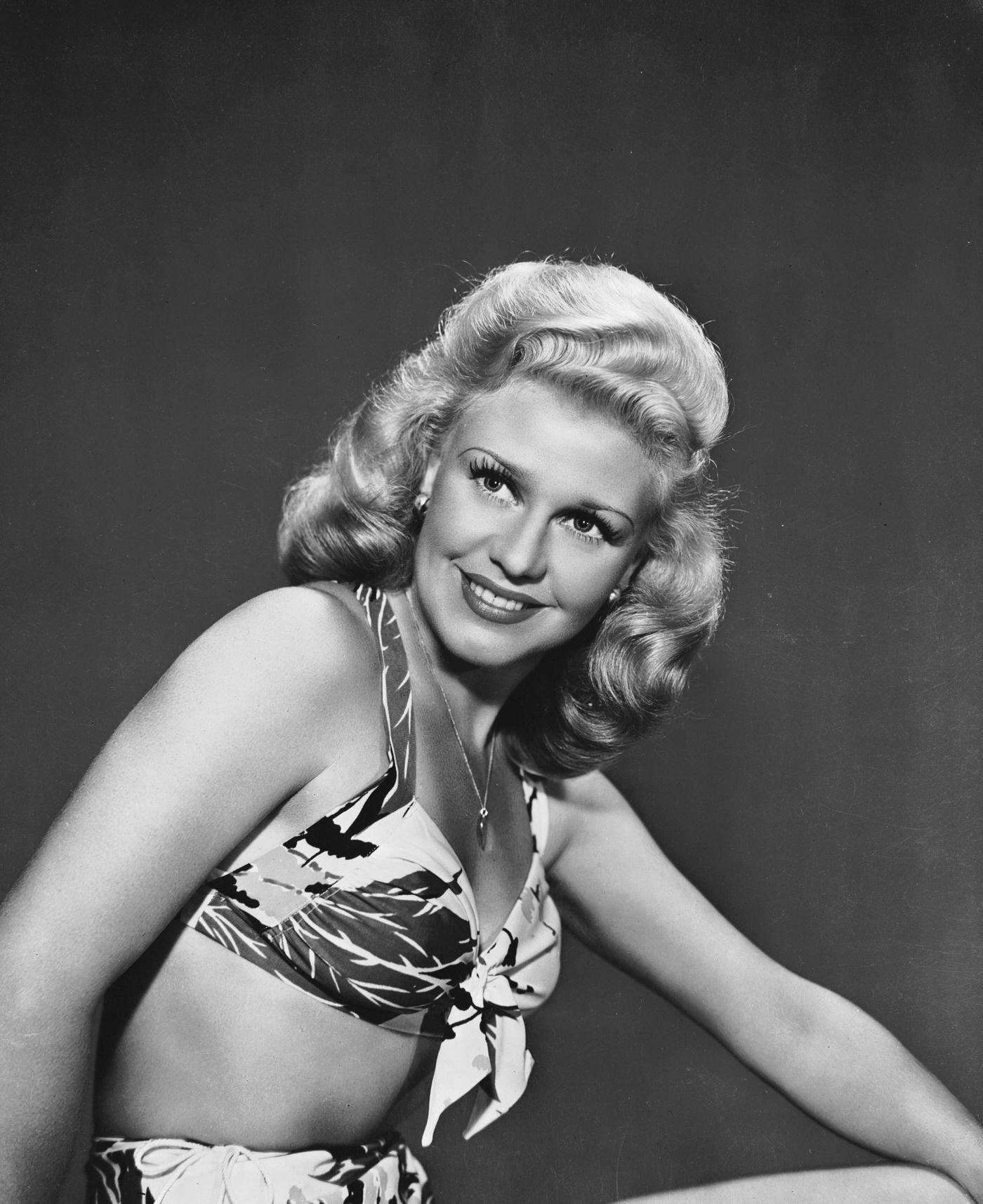 Ginger Rogers, American dancer and actress, wearing a loud patterned bikini, 1944.