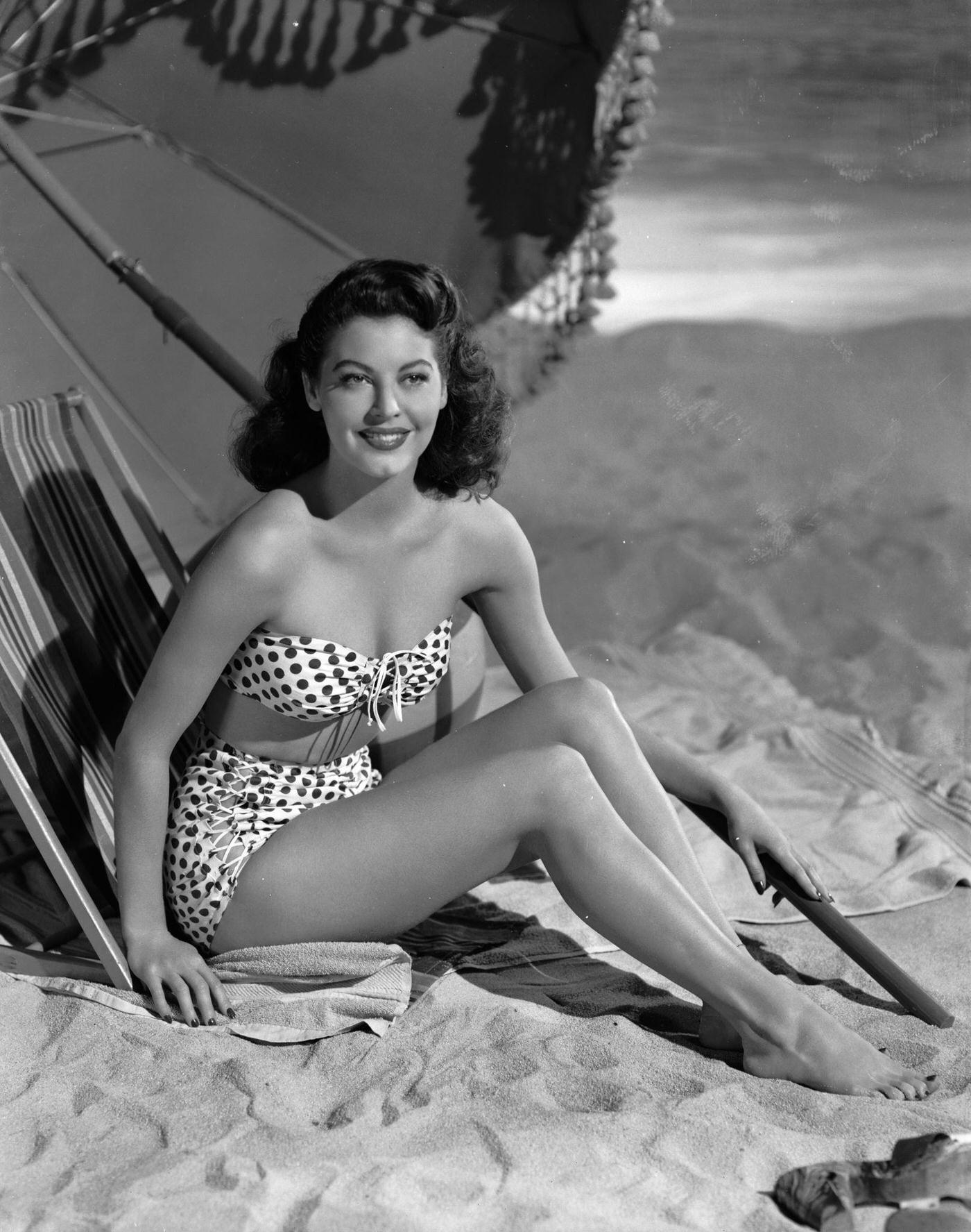 Ava Gardner lounging on the beach in a spotted bikini, December 1944.